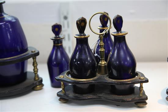 A Regency gilt decorated blue glass three bottle cruet stand,